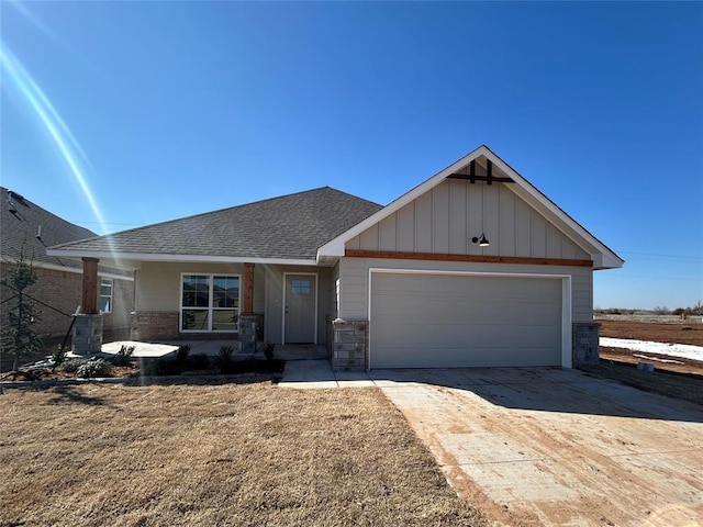 view of front of property featuring board and batten siding, concrete driveway, roof with shingles, and an attached garage