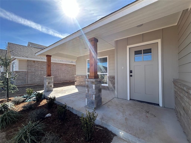 doorway to property featuring brick siding