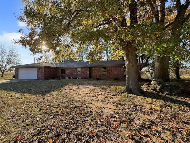 single story home with a garage and a front lawn