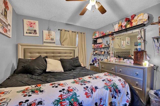 bedroom with a textured ceiling and ceiling fan