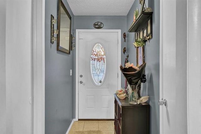 doorway featuring a textured ceiling and light tile patterned flooring