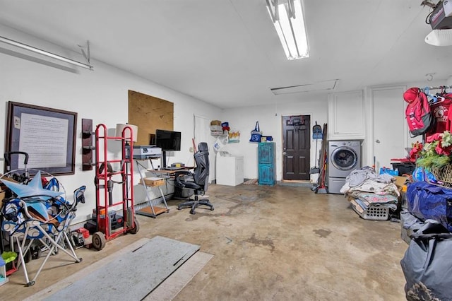 garage with washer / dryer and a garage door opener