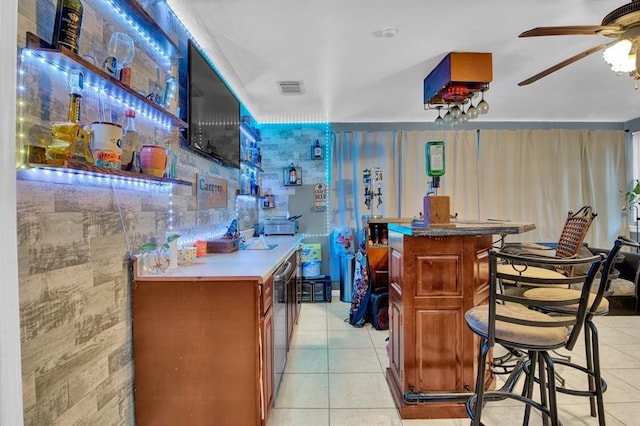 bar featuring ceiling fan and light tile patterned floors