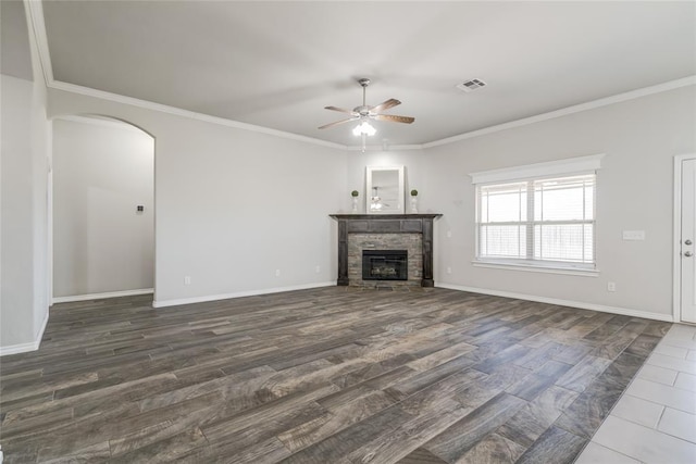 unfurnished living room featuring ornamental molding, dark hardwood / wood-style floors, ceiling fan, and a fireplace