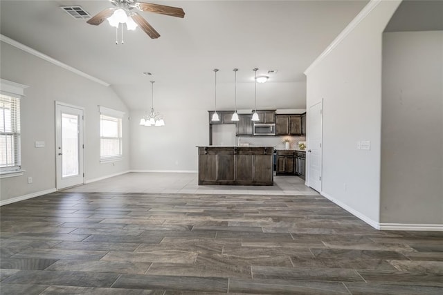 unfurnished living room with crown molding, vaulted ceiling, ceiling fan with notable chandelier, and dark hardwood / wood-style flooring