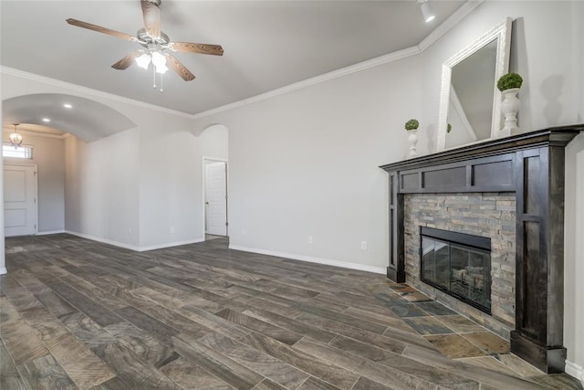 unfurnished living room featuring crown molding, dark hardwood / wood-style flooring, and a stone fireplace