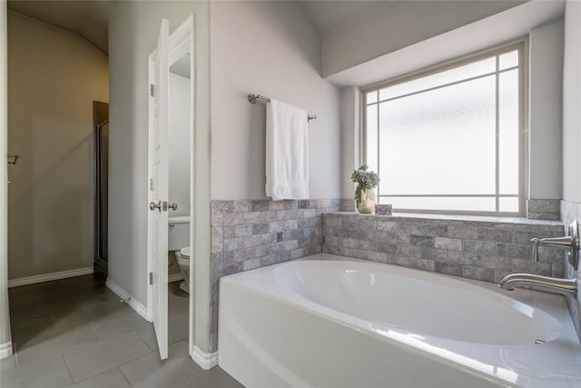 bathroom with tile patterned floors, independent shower and bath, and toilet