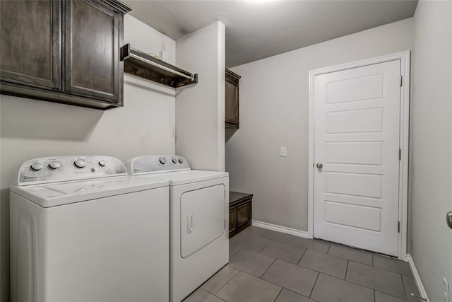 clothes washing area featuring cabinets, light tile patterned floors, and independent washer and dryer