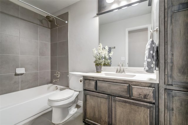 full bathroom with tiled shower / bath, vanity, toilet, and tile patterned flooring