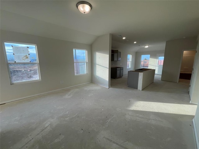 unfurnished living room with vaulted ceiling