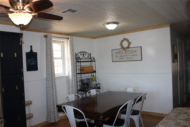 dining area with wood-type flooring, ceiling fan, and ornamental molding