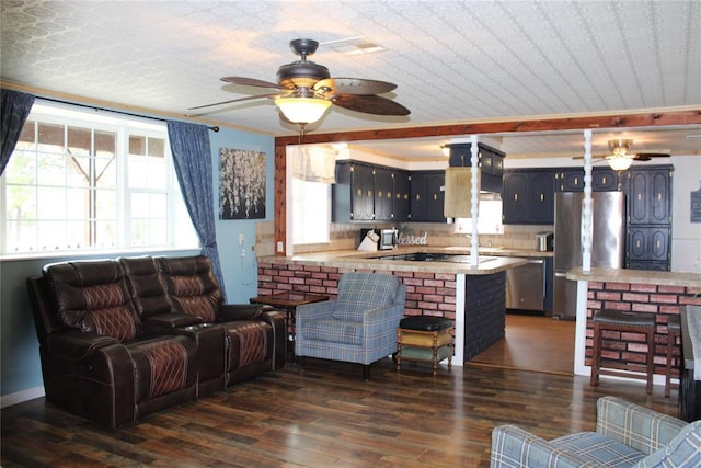 living room featuring ceiling fan and dark hardwood / wood-style floors