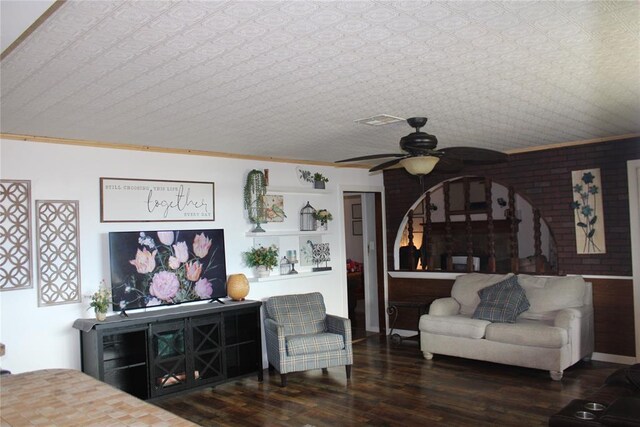 living room featuring ceiling fan, dark hardwood / wood-style flooring, and ornamental molding