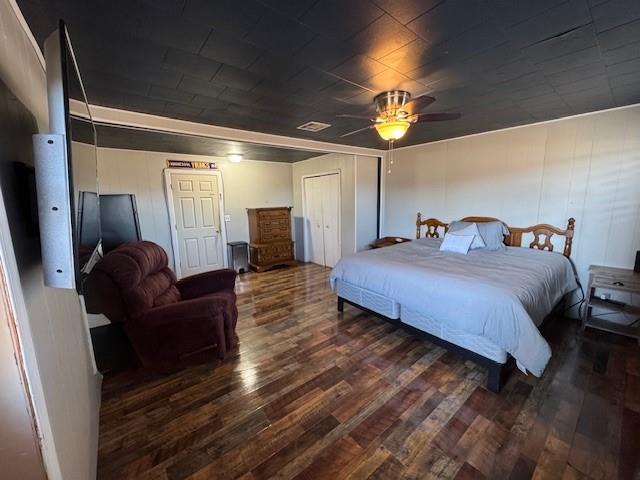 bedroom with ceiling fan and dark wood-type flooring