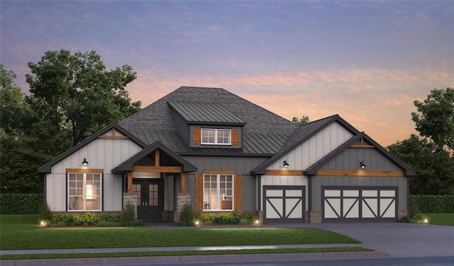 modern inspired farmhouse featuring metal roof, concrete driveway, a yard, board and batten siding, and a standing seam roof