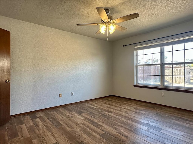 unfurnished room with ceiling fan, dark hardwood / wood-style flooring, and a textured ceiling