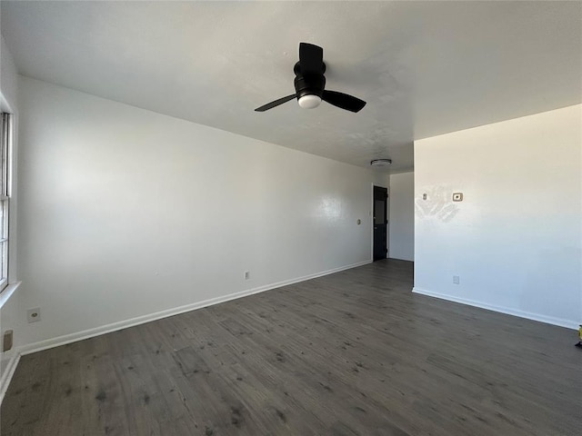 empty room with ceiling fan, baseboards, and dark wood-style flooring