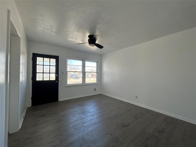 foyer featuring dark wood-style flooring, ceiling fan, a textured ceiling, and baseboards