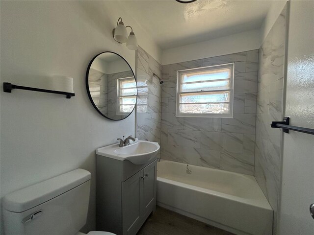 bathroom with toilet, shower / washtub combination, and vanity