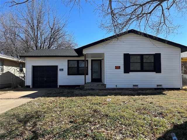 ranch-style home featuring a shingled roof, concrete driveway, an attached garage, crawl space, and a front lawn