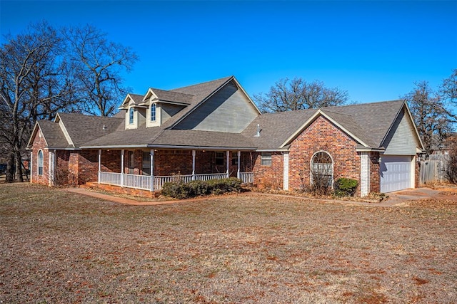 view of front facade featuring covered porch, a front lawn, and a garage