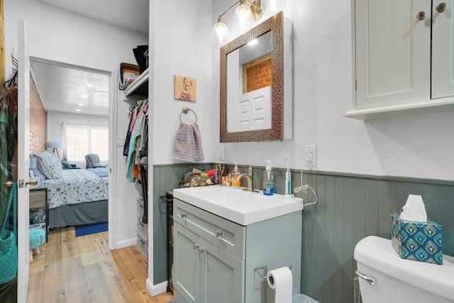 bathroom featuring hardwood / wood-style floors, toilet, and vanity