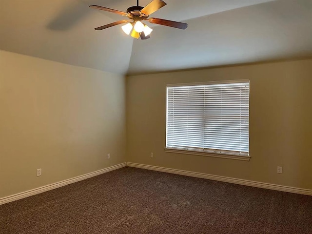 carpeted empty room featuring ceiling fan and vaulted ceiling