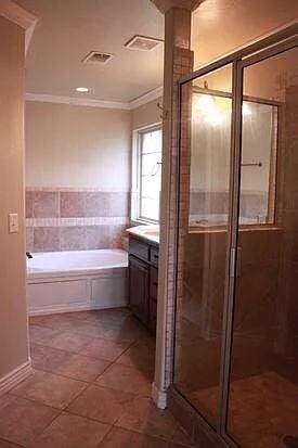 full bath with a garden tub, crown molding, visible vents, a shower stall, and vanity