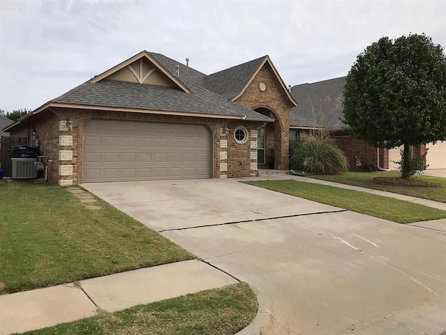 view of front of home with an attached garage, brick siding, a shingled roof, concrete driveway, and a front lawn