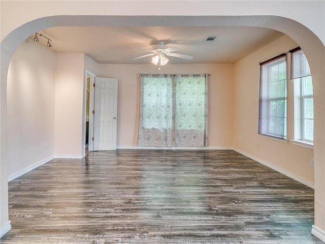 unfurnished room featuring ceiling fan and dark hardwood / wood-style flooring