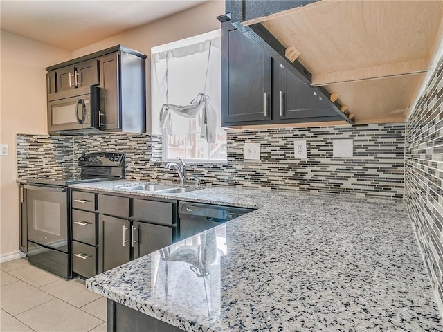 kitchen with sink, backsplash, black appliances, and light stone counters