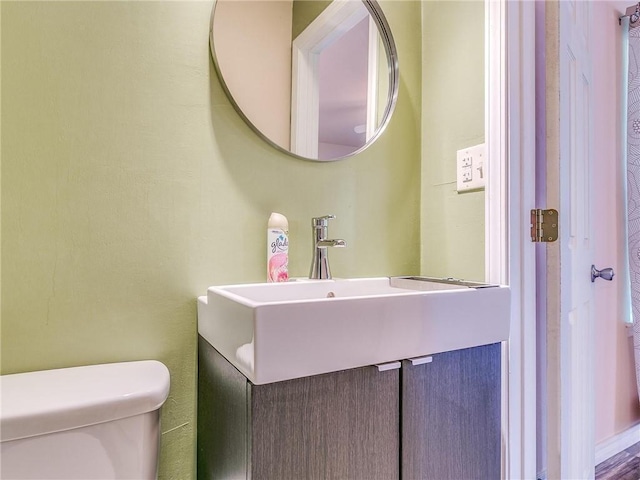 bathroom with toilet and vanity