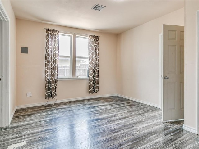 unfurnished room with hardwood / wood-style floors