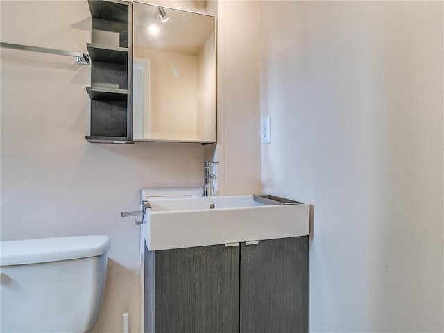 bathroom featuring toilet and vanity