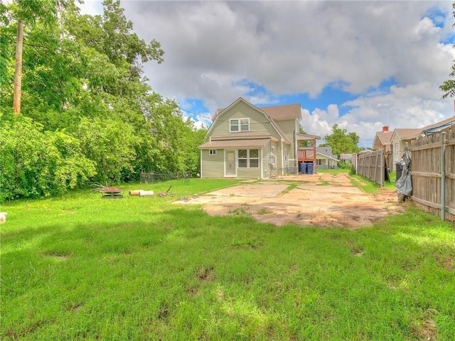 rear view of property with a yard