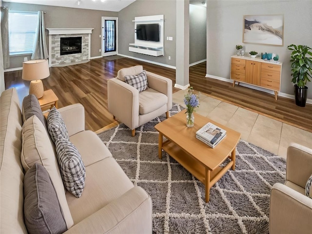 living room featuring lofted ceiling and hardwood / wood-style flooring