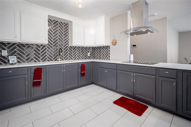 kitchen with white cabinets, gray cabinets, island exhaust hood, and tasteful backsplash