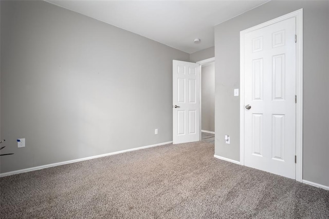 unfurnished bedroom featuring carpet floors and a closet