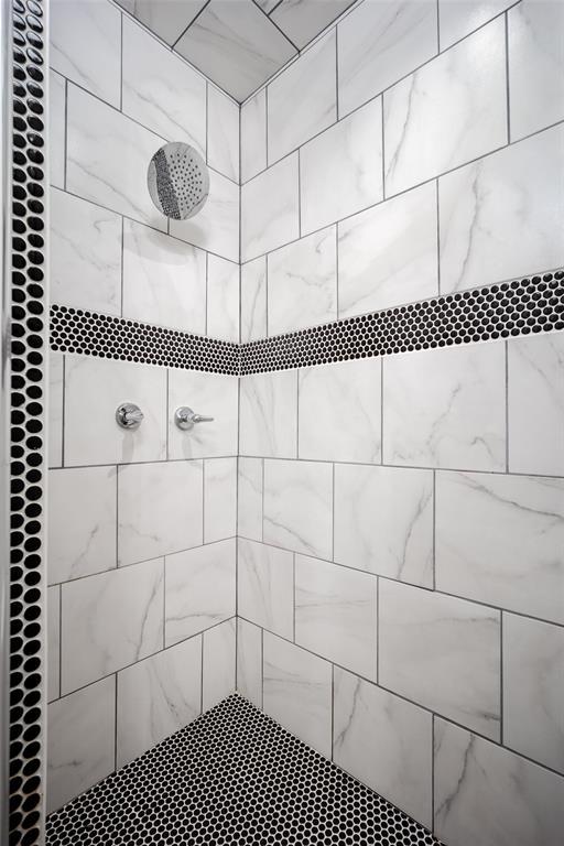 bathroom with a tile shower