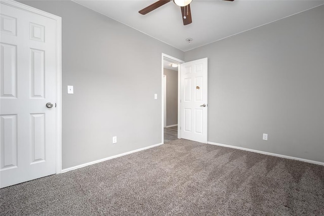 unfurnished bedroom with ceiling fan and carpet