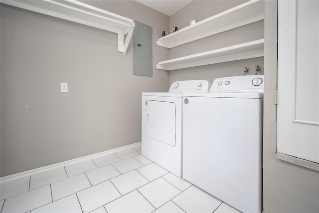 washroom featuring washer and dryer, light tile patterned floors, and electric panel