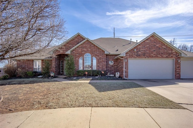 ranch-style house with a garage, concrete driveway, brick siding, and a shingled roof