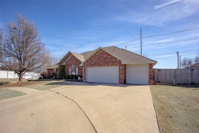 view of front of house featuring a garage, a shingled roof, concrete driveway, fence, and brick siding