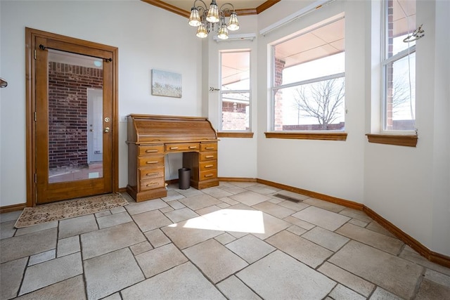 interior space with visible vents, baseboards, a chandelier, and ornamental molding