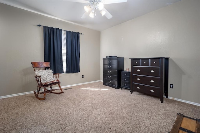 sitting room featuring ceiling fan, carpet flooring, and baseboards