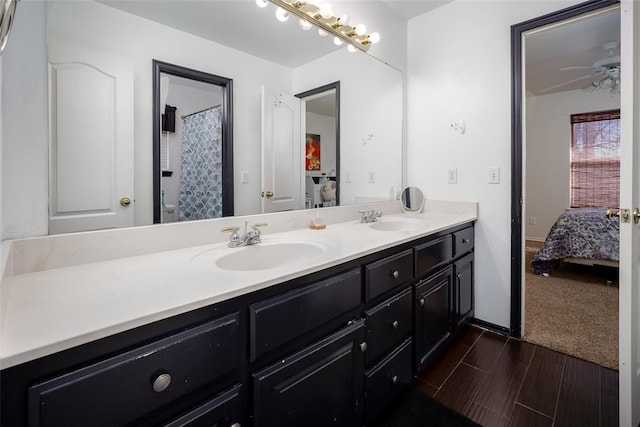 full bath featuring ensuite bathroom, ceiling fan, double vanity, and a sink