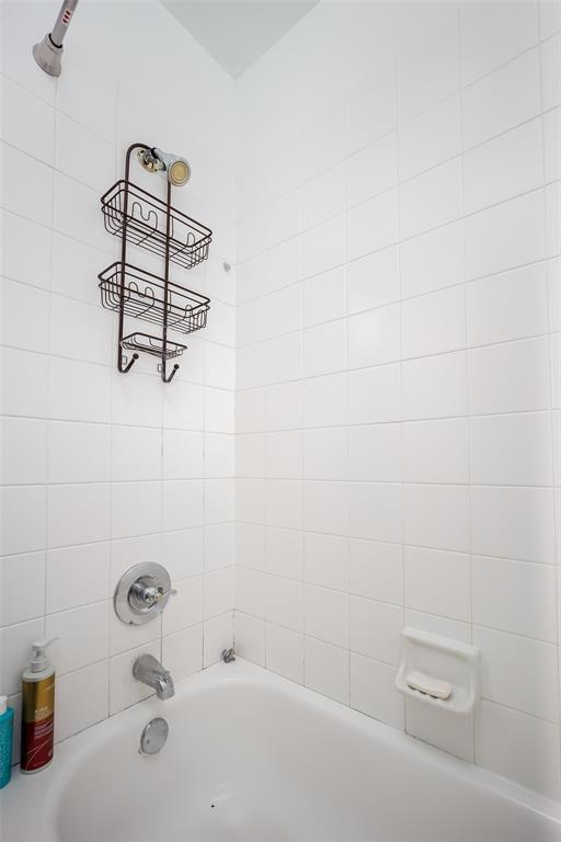 full bathroom with shower / washtub combination