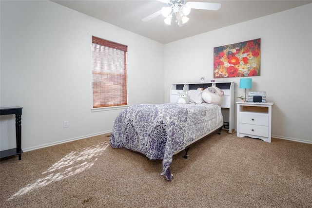 carpeted bedroom featuring ceiling fan and baseboards