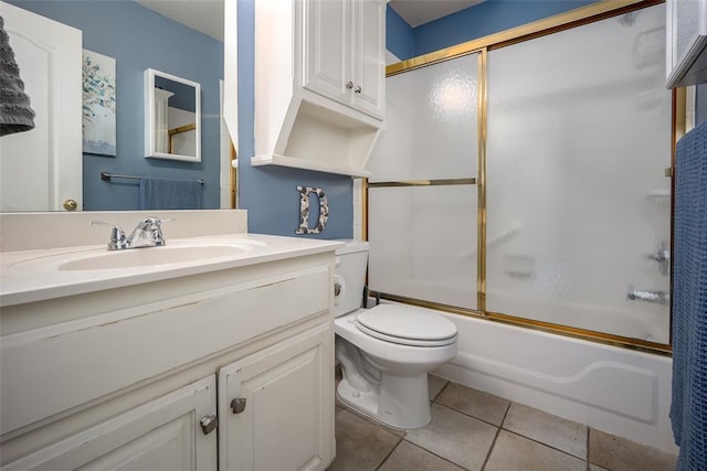 bathroom featuring bath / shower combo with glass door, vanity, toilet, and tile patterned floors