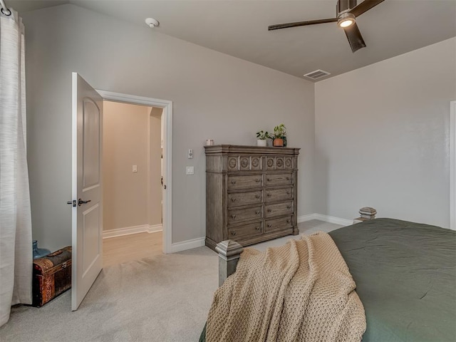 bedroom featuring vaulted ceiling, ceiling fan, and light colored carpet